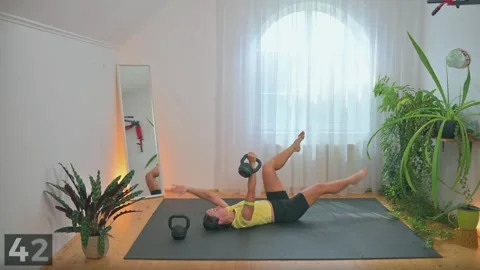 Dead bug demonstration with one kettlebell